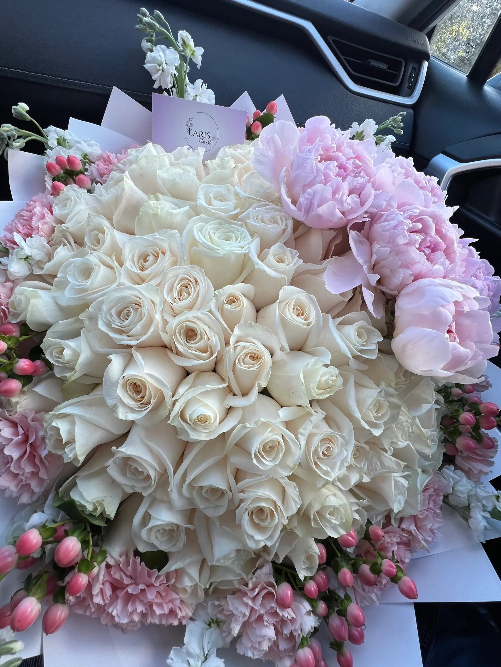 Large bouquet of white roses with pink peonies and carnations