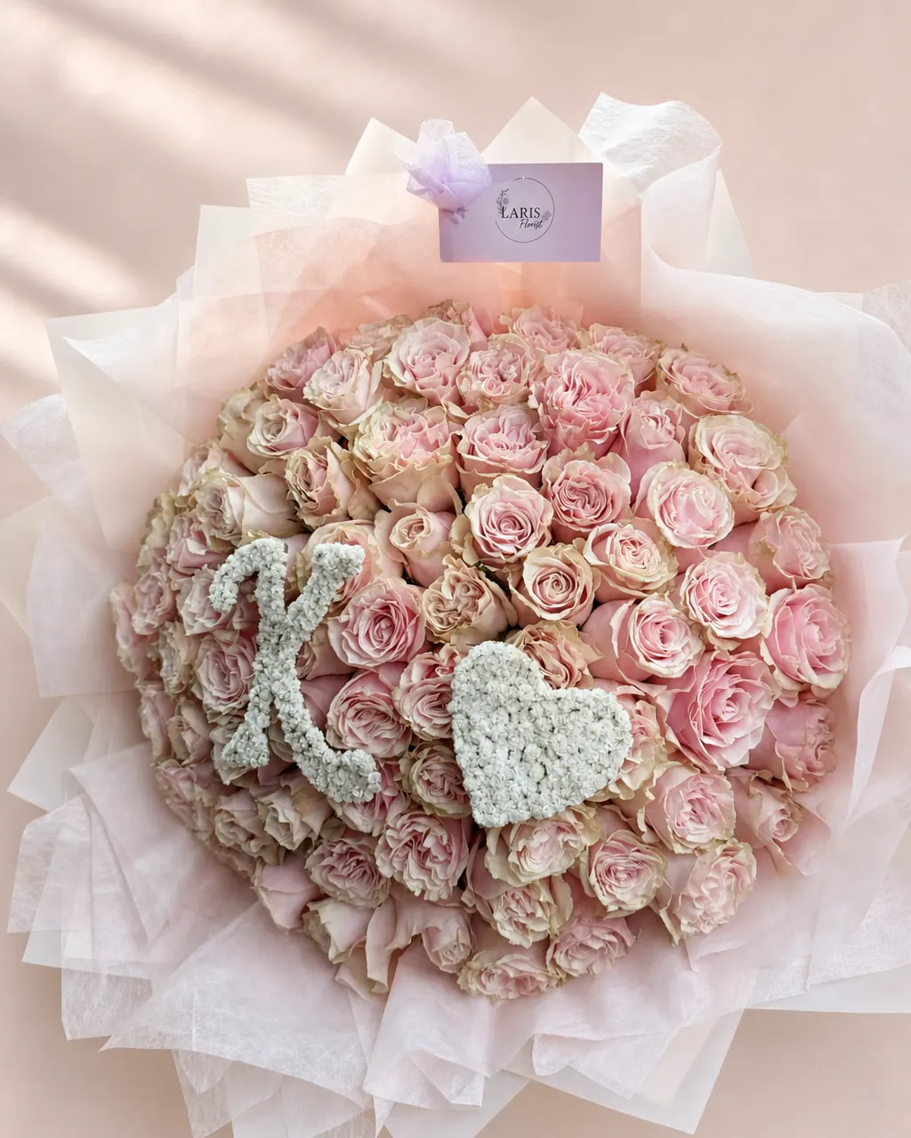 Antique Blush: 50 pink roses with initial, double wrapped, photographed on a blush backdrop