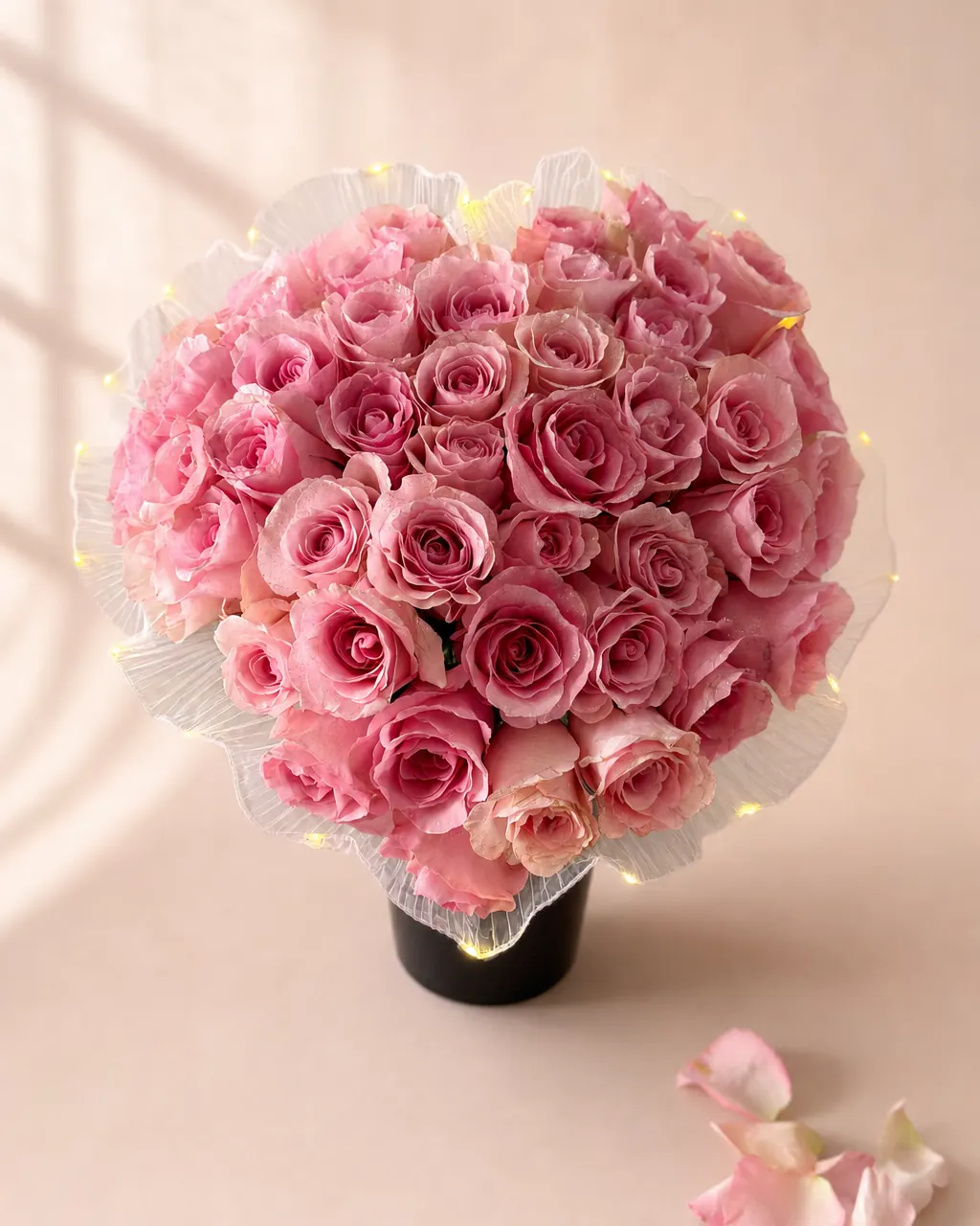 Heartlight: pink roses shaped into a heart with fairy lights, on a blush backdrop