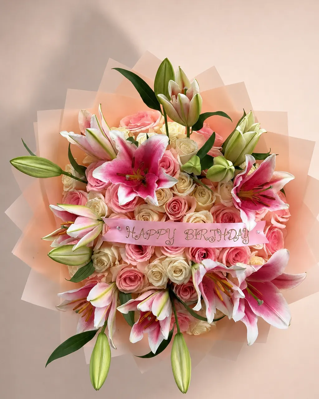 Lily Garland: 50 pink and white roses ringed with lilies, photographed on a blush backdrop