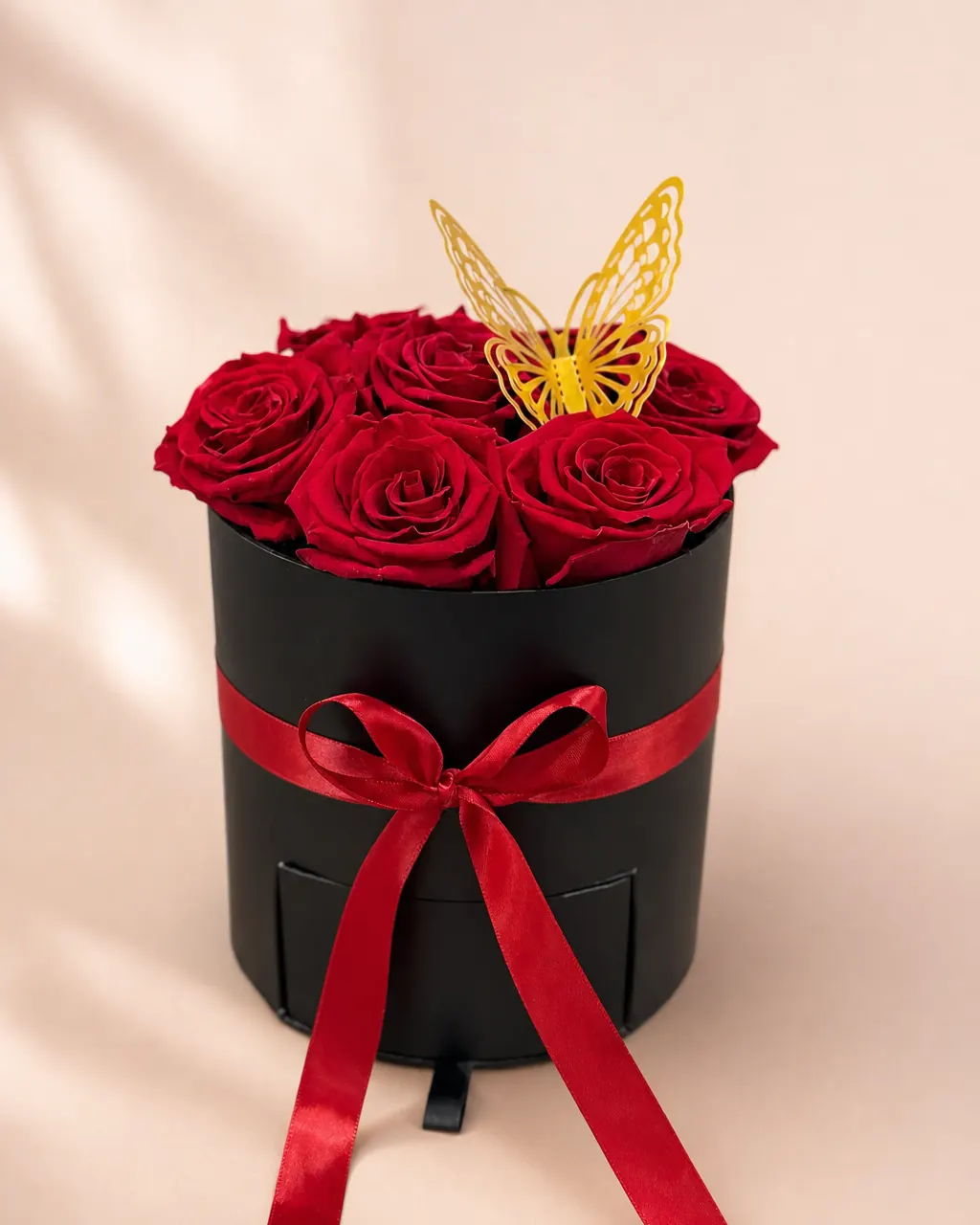 Little Red Hatbox: Premium red roses in a black hat box, photographed on a blush backdrop