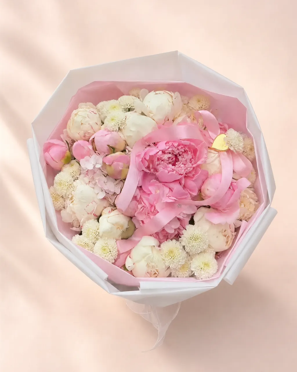 Peony Parcel: 10 mixed peonies with hydrangeas and filler, photographed on a blush backdrop