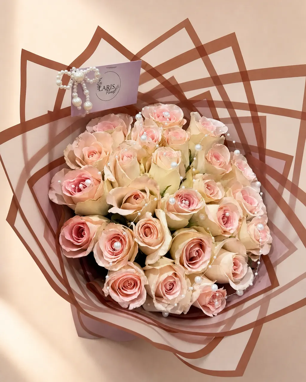 Rosewater: 25 premium pink roses in layered blush wrap, photographed on a blush backdrop