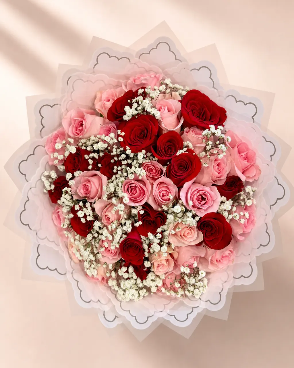 Strawberry Lace: 50 red and pink roses with baby's breath, photographed on a blush backdrop
