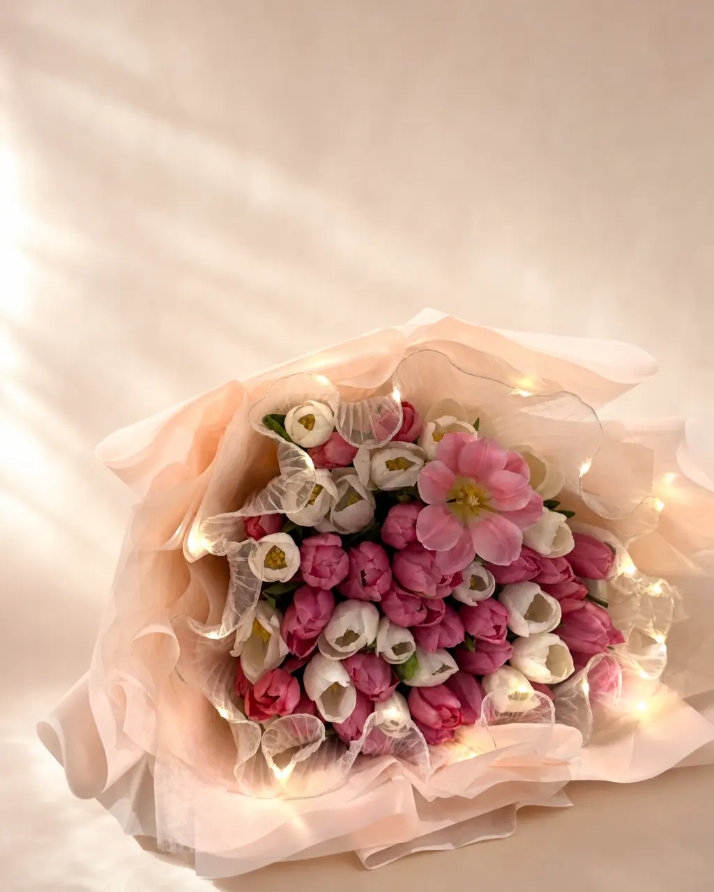 Tulip Glow: Mixed colour tulips with LED lights, photographed on a blush backdrop