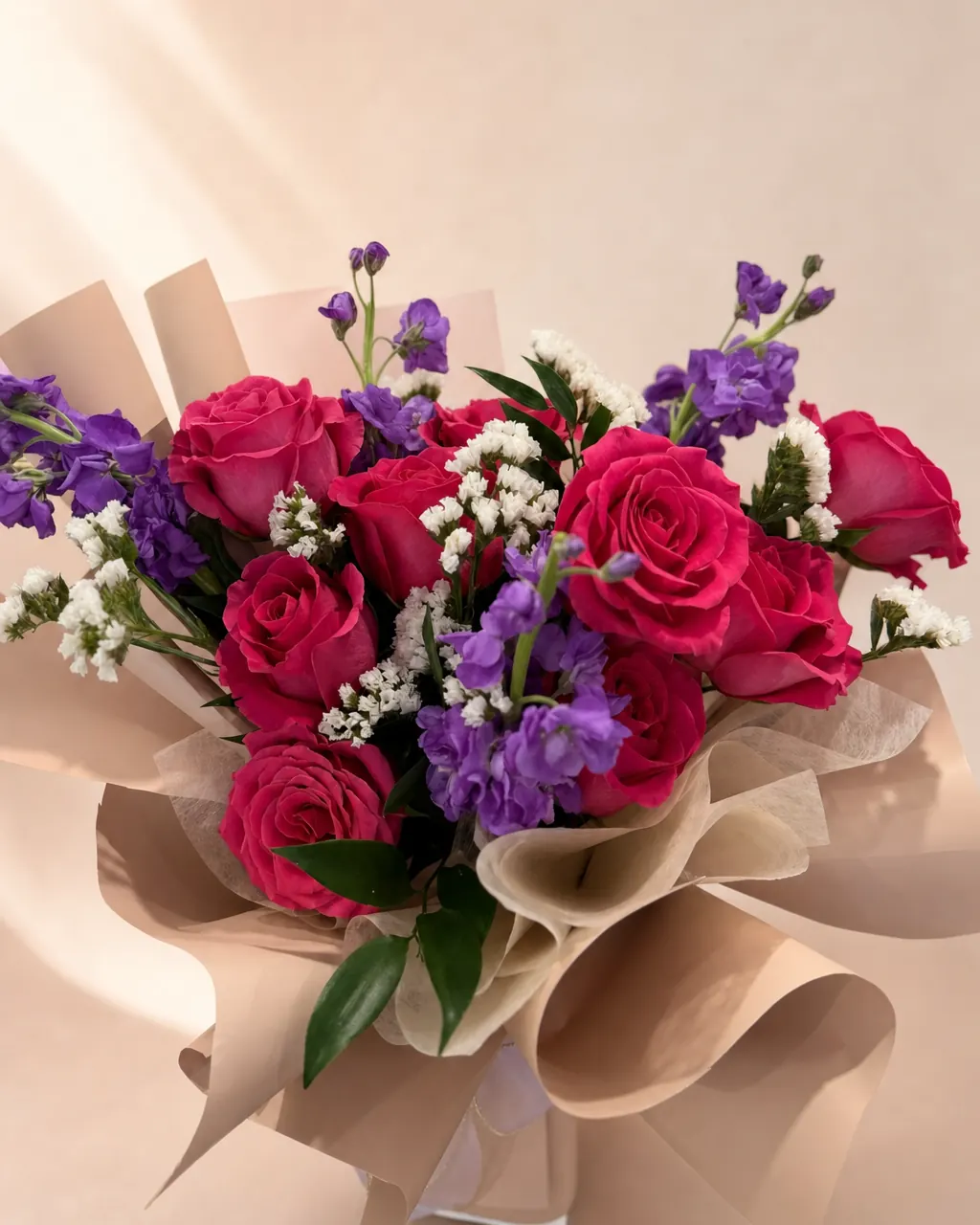 Violet Cerise: Premium roses with stock and fillers, photographed on a blush backdrop
